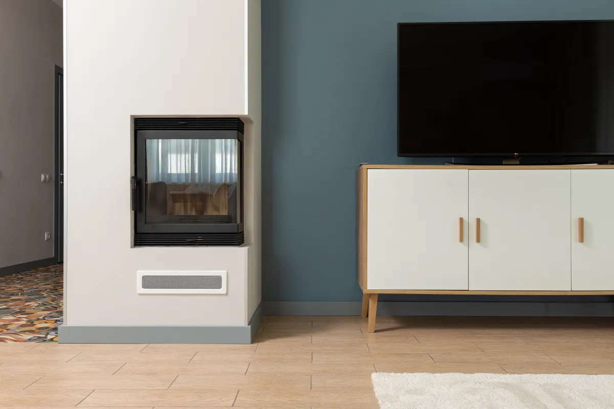 Piso contemporáneo con un gran televisor sobre un mueble blanco junto a una chimenea empotrada